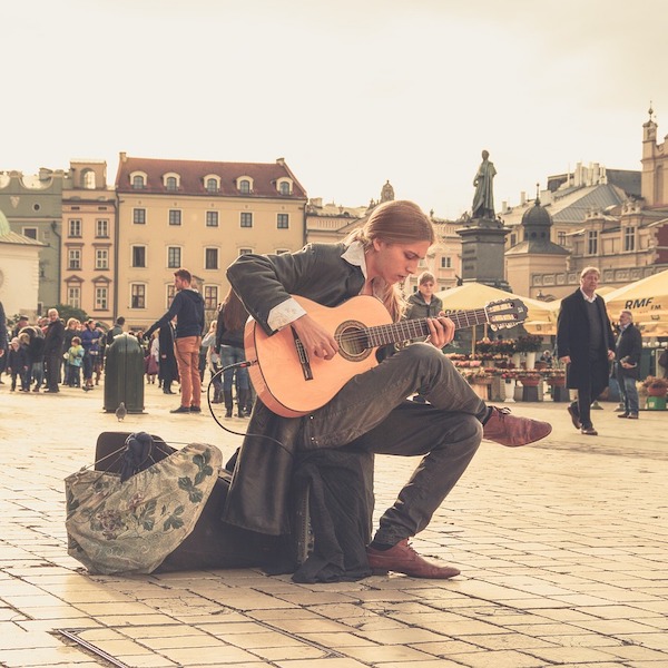 Man Playing Guitar in Plaza